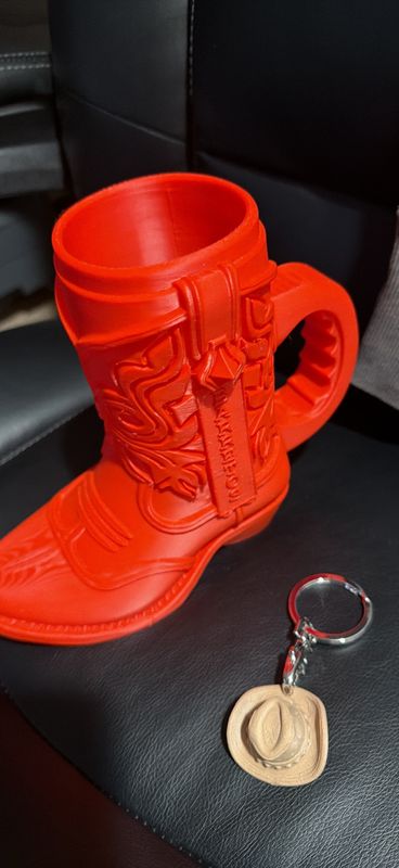 3D-printed cowboy boot can koozie with a small cowboy hat keychain