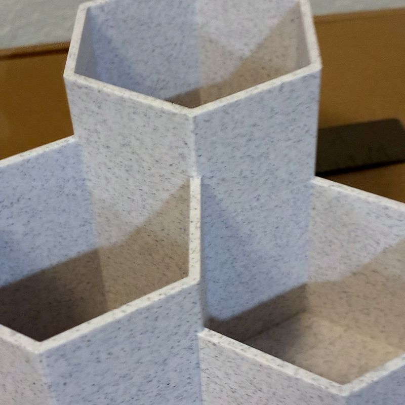 Set of three hexagonal 3D-printed desk cups holding pens