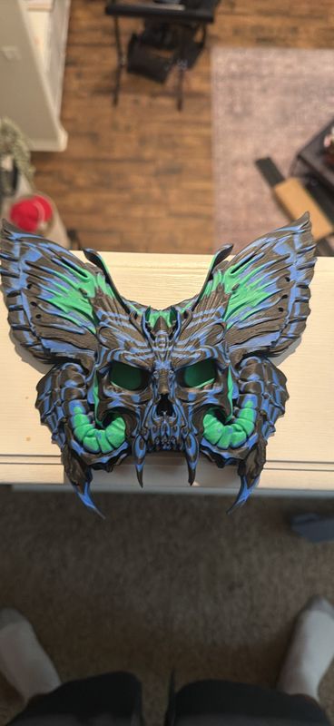 3D-printed horned skull with moth wings wall art