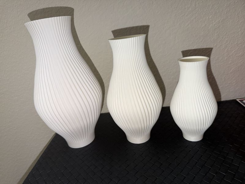 Three ribbed 3D-printed vases in a travertine finish