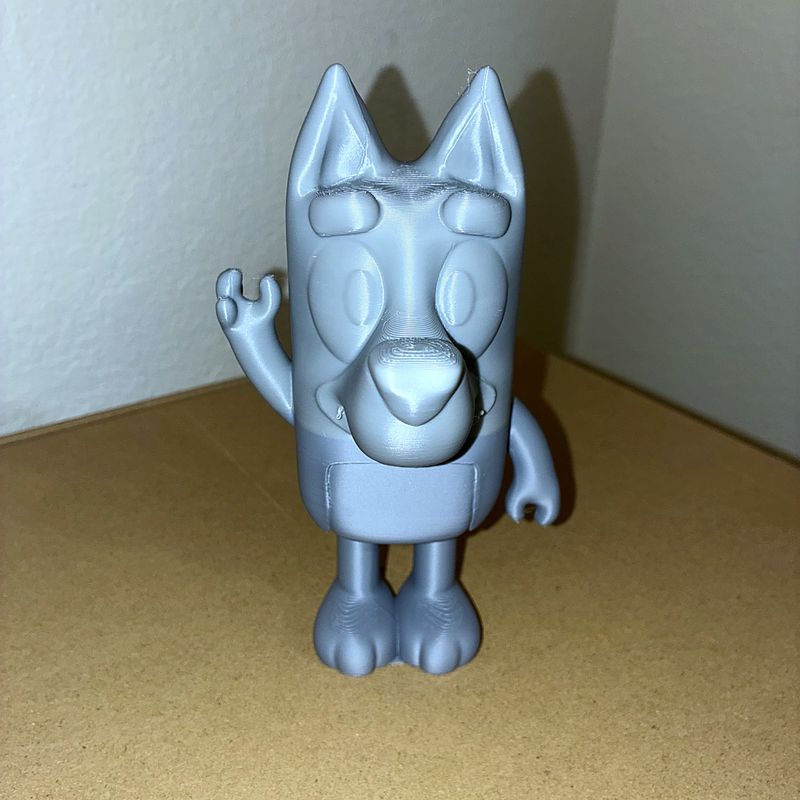 Blue 3D-printed waving puppy figurine