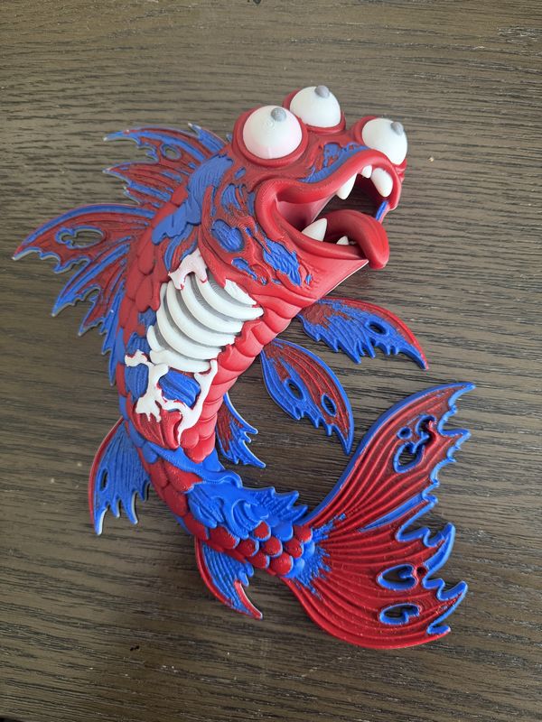 Red and blue 3D-printed zombie koi fish wall art with exposed white ribs